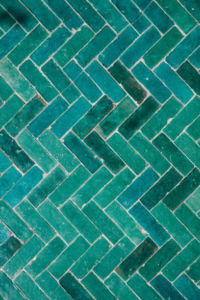 istock Marrakech green blue glazed tiles mosaic herringbone pattern on floor of Moroccan Riad 1701127917