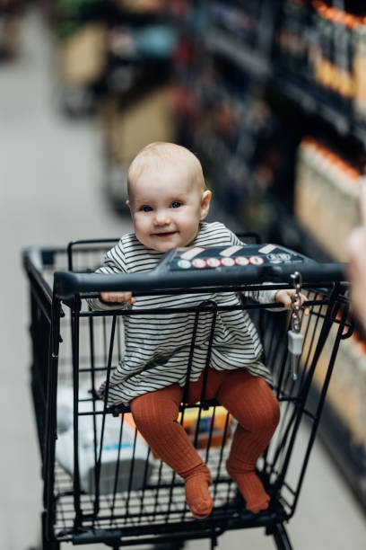 istock Smiles in the Aisles: Baby in Shopping Cart 1701128905