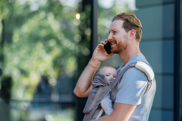 istock Urban Parenthood: Father and Baby on the Move 1701129298