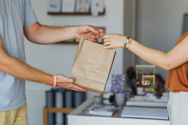 istock Customer Receives Paper Bag 1701129387