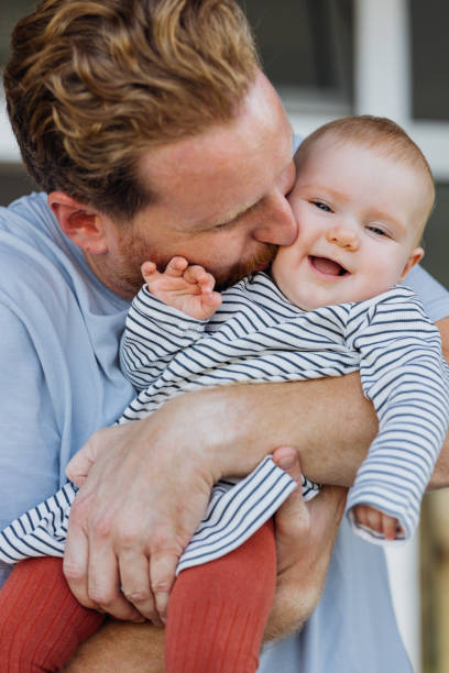 istock Happy Father Kissing His Baby 1701129426