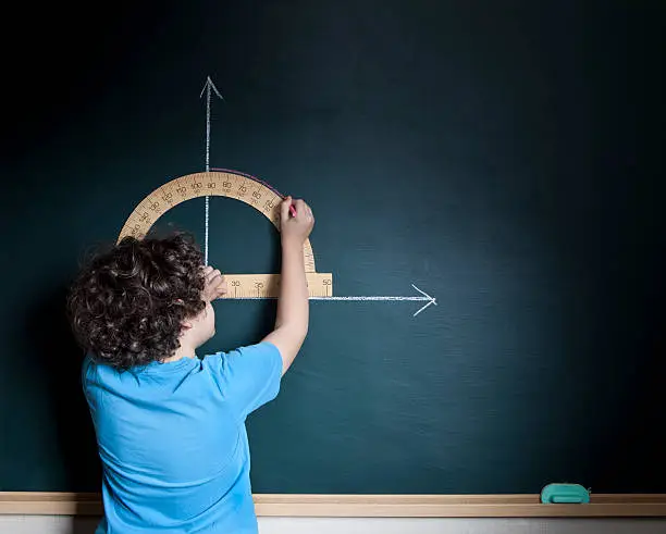 Photo of Child calculating on blackboard