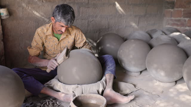 Indian potter working in his workshop, Rajasthan, India