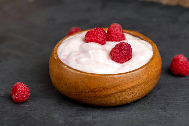 istock fresh yogurt with raspberry flavor, close up 1701147681