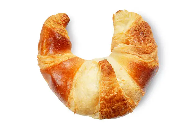 Overhead view of a single croissant isolated on white.