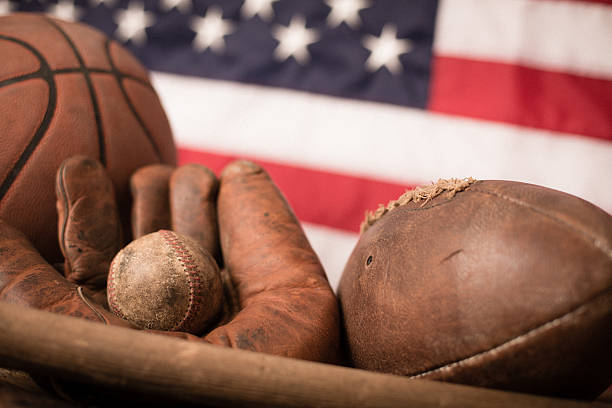 винтажный спортивное оборудование перед американский флаг - baseballs baseball sport american culture стоковые фото и изображения