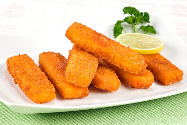 Fried fish fingers Fried fish fingers on plate. Selective focus, shallow DOF. fish stick stock pictures, royalty-free photos & images