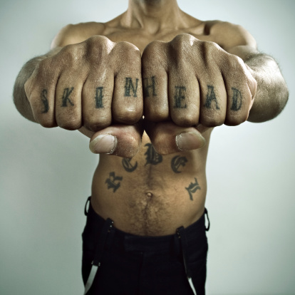 Antiracist original black skinhead showing his tattoos.
