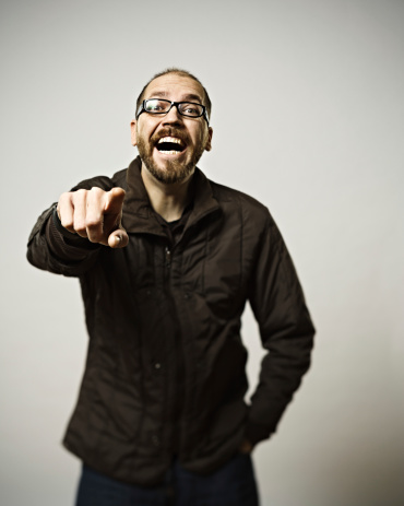 Man laughing and pointing to camera