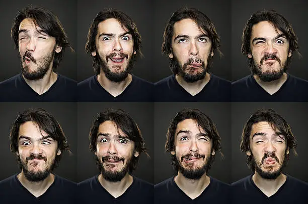 Different grimacing expressions of a young man. 