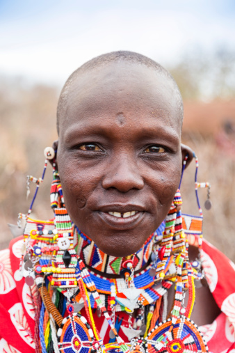 Portrait of maasai woman with traditional jewellery and pierced ealobes.