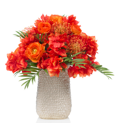 Bouquet of gerbera flowers in rustic vase on table in old-fashioned living room.
