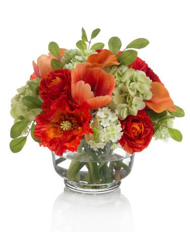 A mixed fall bouquet with tulips and ranunculus in a glass revere bowl. This image has an embedded path which may be used to delete the reflection if desired. Photographed on a bright white background. Extremely high quality faux flowers.