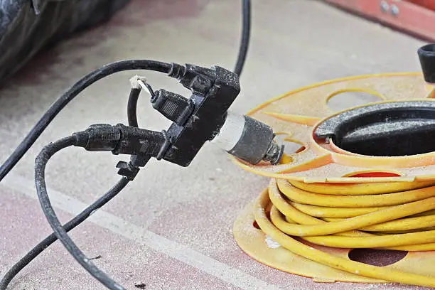 Electric power extension cords. With this mess of a dangerous contraption, a carpenter at a construction site has broken some common sense rules about using electricity safety.