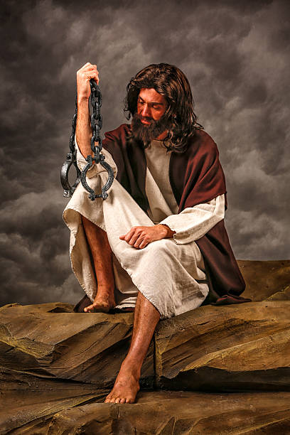 istock Jesus Sitting on rock holding chains 170122272