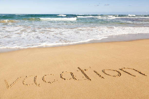 istock Vacation hand written in the sand beach ocean 170122655