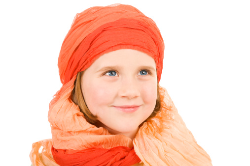 Adorable little girl blue eyes head scarf bright orange isolated