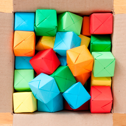 Top view of paper origami cubes thrown inside box