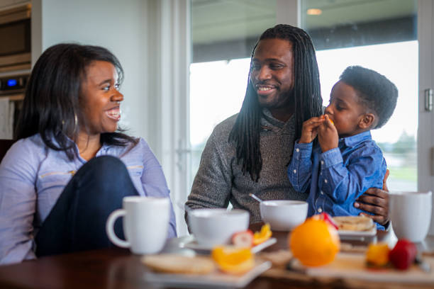 istock Smiling family of three eats an at home breakfast 1701294297