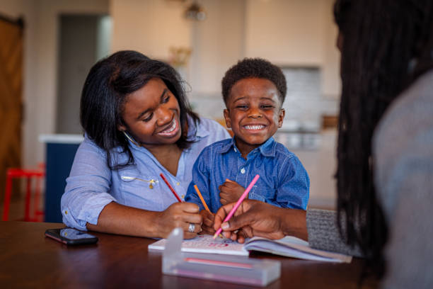 istock Smiling mother and young son practice their writing skills 1701294828