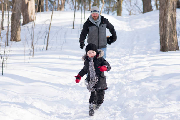 istock Father and Son in the Snow 1701309975