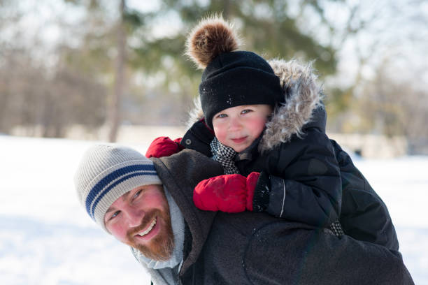 istock Father and Son Portrait in the Snow 1701309978