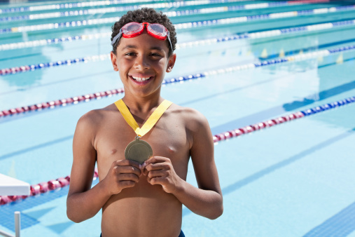 Boy with swimming medal, 10 years.