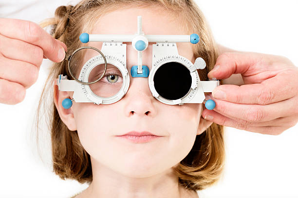 Young Girl Having Her Eyesight Checked. Young girl, 7 years old, having her eyesight checked. myopia stock pictures, royalty-free photos & images