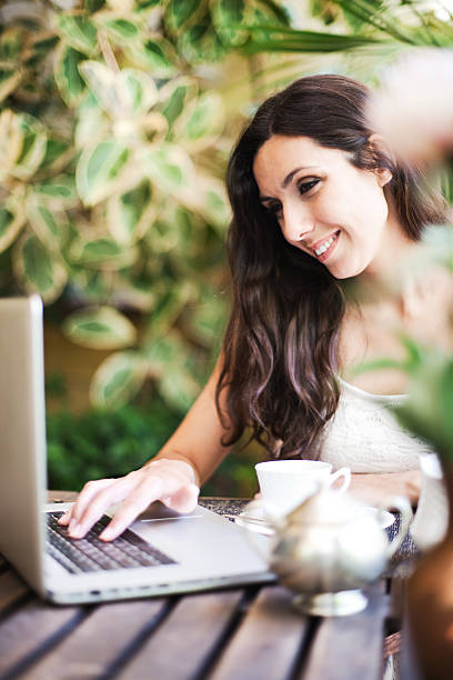 istock Beautiful woman having breakfast on terrace with lap top. 170132781
