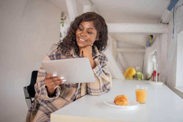 istock Happy young woman digital tablet 1701333855