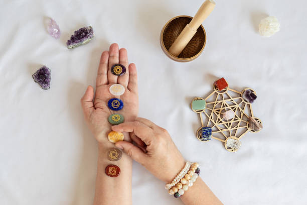 Healing reiki chakra crystals on woman's hands. Gemstones for wellbeing, meditation, relaxation Healing reiki chakra crystals on woman's hands. Gemstones therapy for wellbeing, meditation, destress, relaxation, metaphysical, spiritual practices. Energetical power concept crystal altar stock pictures, royalty-free photos & images