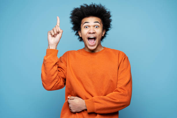 istock Young excited African American man holding finger up having creative idea 1701339501