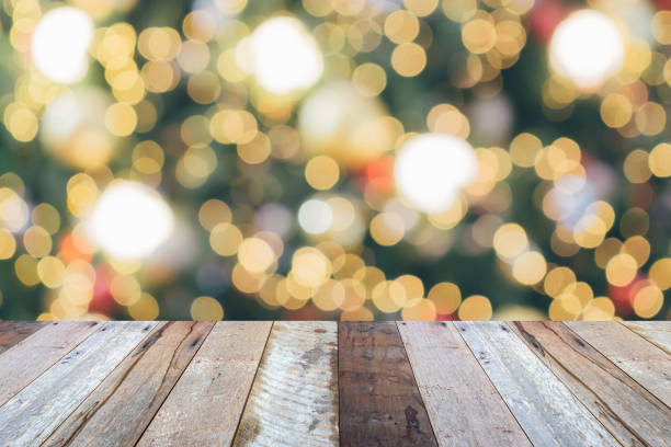 istock Empty wood table top with blur Christmas tree with bokeh light background 1701346642