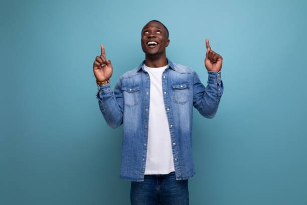 istock young handsome african guy in urban clothes gesturing pointing to advertising space on isolated background with copy space 1701347214