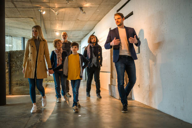 istock Male Caucasian Museum Guide and a Mixed Group 1701351077