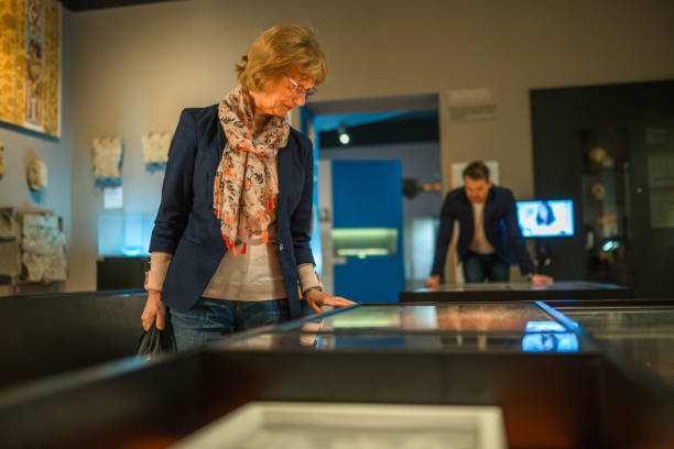 istock Female Caucasian Senior Strolling through an Exhibition 1701351613