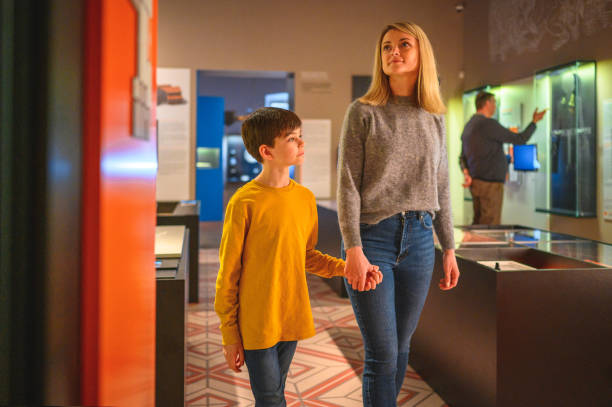 istock Boy and his Mom Walking Through a Museum Hand in Hand 1701351625