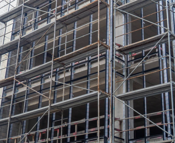 istock Construction of a concrete house. Modern buildings. Scaffolding. 1701370359