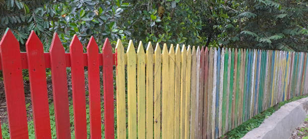 istock Multi colored rainbow wooden fence in garden background 1701407381