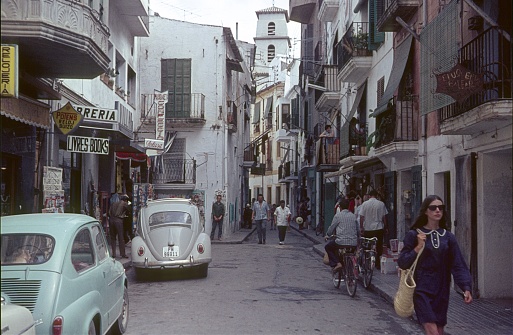 Ibiza Town, Ibiza, Catalonia, Spain, 1967. Street scene with pedestrians, shops and buildings in the old town of Ibiza.