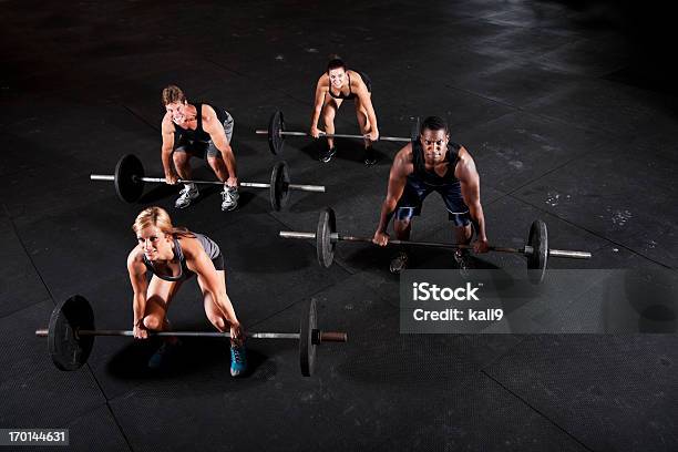 Group Of Body Builders Lifting Barbells Stock Photo - Download Image Now - Coach, Powerlifting, Weightlifting