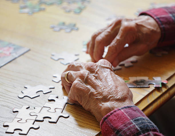 Senior Man Assembling Jigsaw Puzzle stock photo