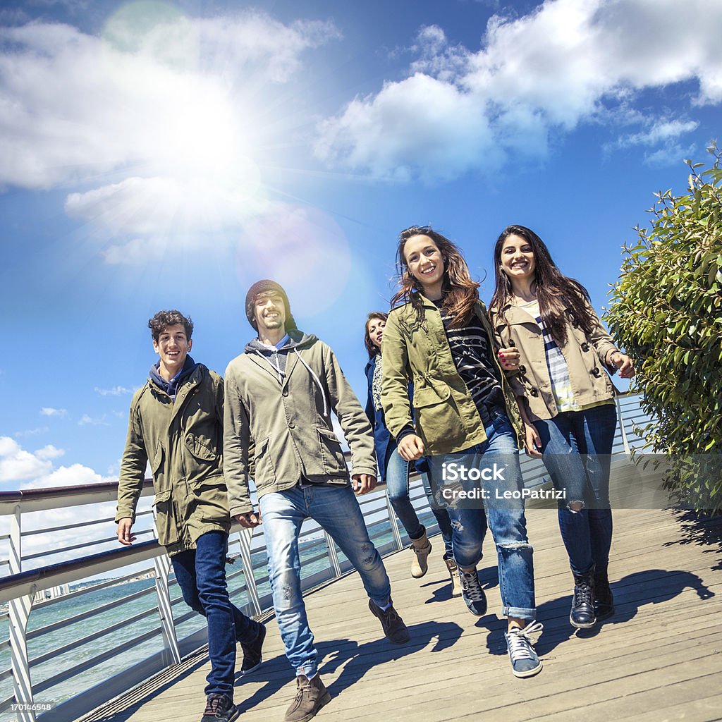 Happy group of friends Happy group of italians friends on the promenade. University Student Stock Photo