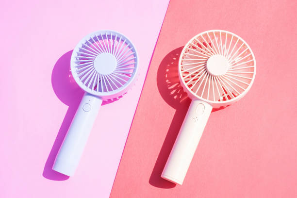istock Small portable mini fans on pink background close-up. 1701472849