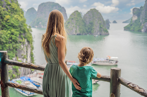 Mom and son travelers in Halong Bay. Vietnam. Travel to Asia, happiness emotion, summer holiday concept. Picturesque sea landscape. Ha Long Bay, Vietnam. After coronavirus COVID 19.