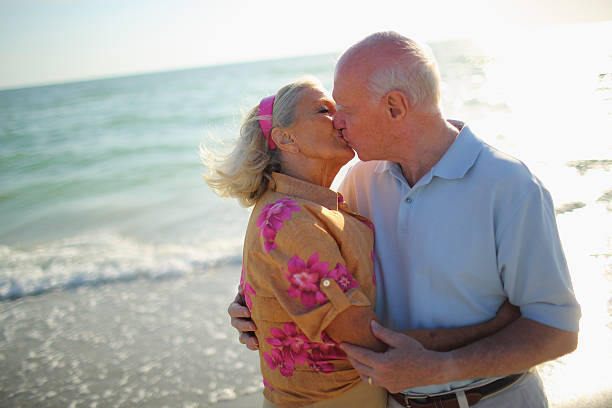 istock Senior Couple kissing on the beach 170149015