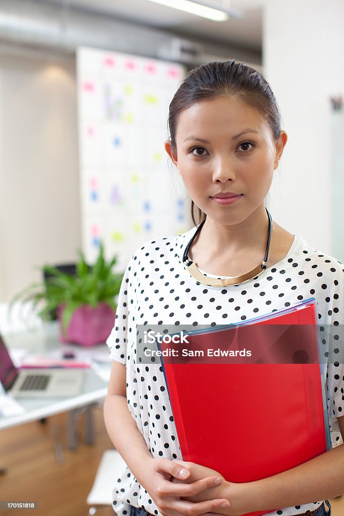  businesswoman with folder in office  25-29 Years Stock Photo