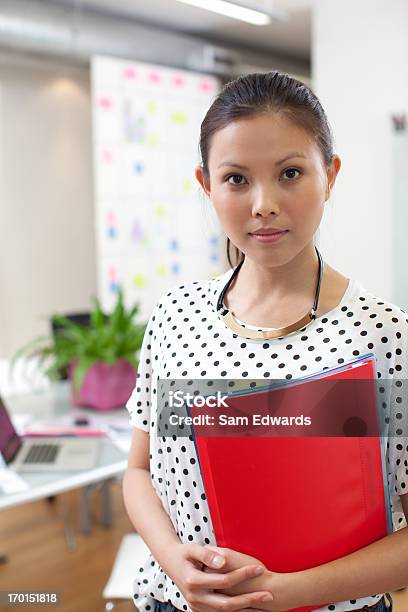 Businesswoman With Folder In Office Stock Photo - Download Image Now - 25-29 Years, Adult, Adults Only