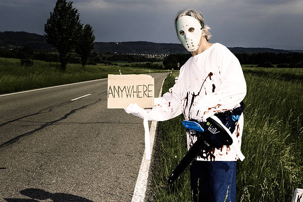 chainsaw murderer hitchhiking chainsaw murderer trying to get a ride. any destination is fine for him. murderer photos stock pictures, royalty-free photos & images