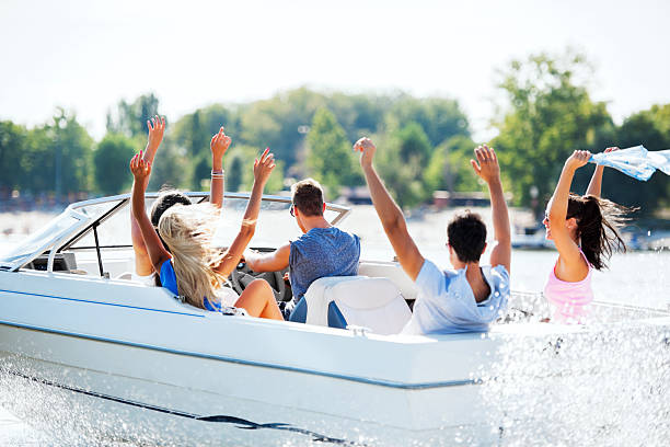 istock Cheerful young people riding in a speedboat 170155533